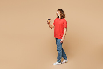 Full body young man he wearing red t-shirt casual clothes hold takeaway delivery craft paper brown...