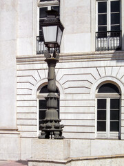 Lisbon, Portugal. Rossio Square. Large and imposing 19th Century ornate bronze streetlamp in front of the D. Maria National Theater.