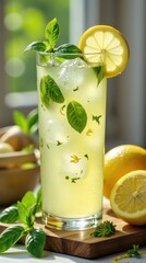 food photography of basil lemonade, served in a tall, elegant glass filled with ice cubes that glisten under the soft natural light.