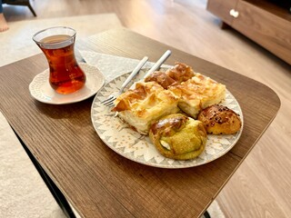Homemade Turkish pastry with traditional tea on wooden table