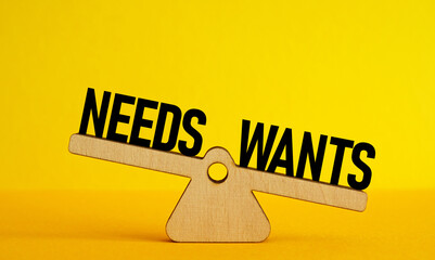 Scales with the words wants and needs. Priorities.