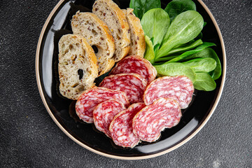 Dry-cured sausage salami appetizer dish fresh gourmet food background on the table rustic food top...