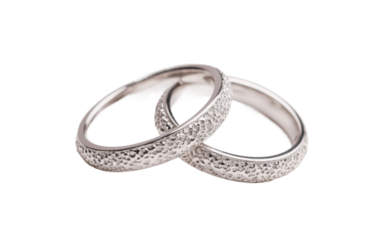 Elegant pair of textured silver rings on white background, cut out