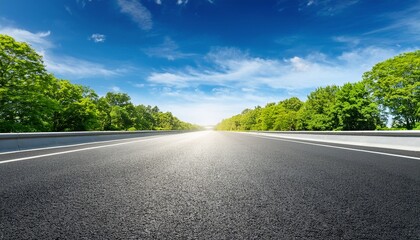 empty asphalt road with green trees and bright blue sky background