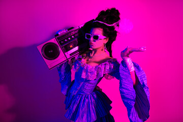 Stylized young woman in vintage baroque costume with modern glam attitude and emphasizing ultraviolet neon colors
