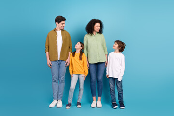Fototapeta premium Happy family standing together in casual stylish clothes with blue background