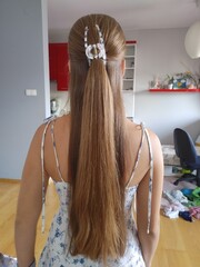 Back View of Woman with Extremely Long Straight Brown Hair in White Summer Dress with Hair Clip
