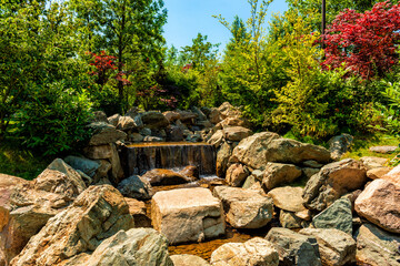 A stream flowing through a bed littered with rocks