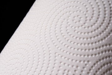 Texture of white paper towel on black background. Macro. Soft, delicate paper.