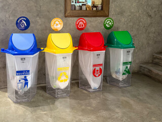 Colorful recycling bins displayed in an indoor setting for waste separation