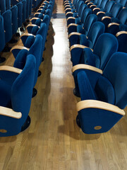 Photo documentation of rows of blue seats in an empty theater