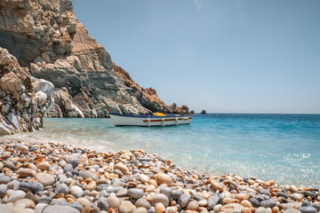 Seychelles beach the exotic swimming spot and cave in Ikaria Greece, fishing boat and touristic resort, summer vacation, Mediterranean Sea