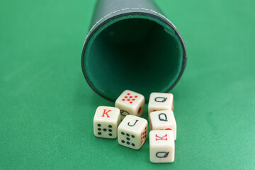 Dice roll reveals cards on a green felt surface in a playful gam
