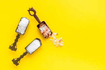 White and pink salt - coarse and finely - in metal spoons. Salt for spa, salt baths or cooking