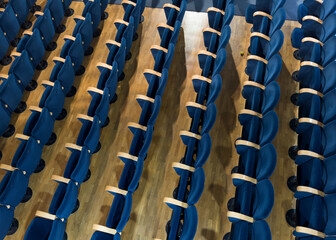Photo documentation of rows of blue seats in an empty theater