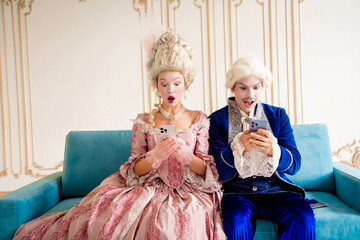 Couple in Baroque Costumes Surprised by Modern Phones at a Luxurious Home