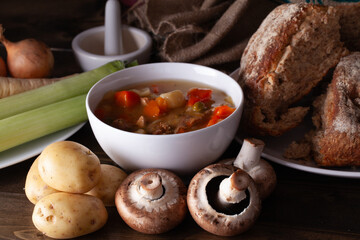 Healthy winter soup in a bowl with fresh ingredients