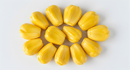 Fototapeta premium Bright yellow jackfruit segments creatively arranged on a pristine white backdrop