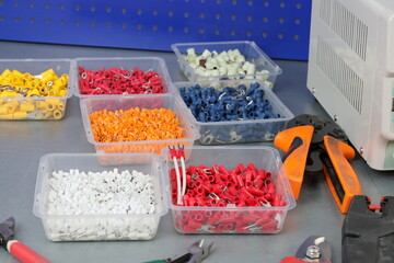 Metal lugs with colored plastic base for stranded copper wires. 