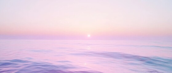 The sun sets behind a hazy horizon, casting a soft pink glow over a calm, endless ocean under a pastel sky.