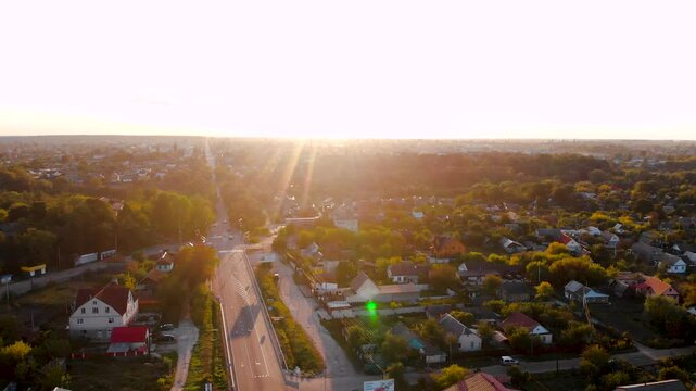 Aerial view of Korostyshiv city entrance through private houses at sunset, Zhytomyr region, Ukraine
