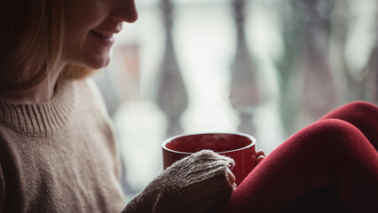 Young woman relaxing indoors in winter