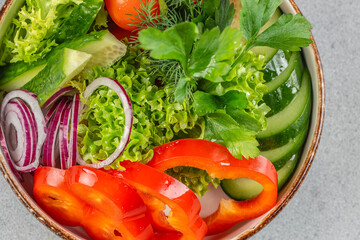 vegan salad from green leaves mix and vegetables in bowl. Healthy green vegetable salad, diet menu. Top view