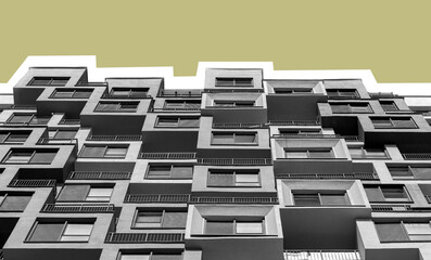 Building with gray exterior. Modern high rise multistorey condominium in developing downtown...