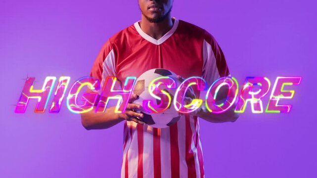 Soccer player holding ball with High Score text animation over purple background