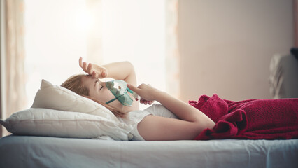 Young woman struggling with virus and asthma using oxygen mask outdoors