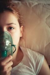 Female patient wearing oxygen mask for breathing support at home