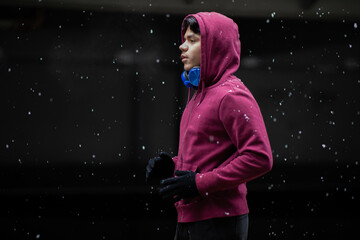 Young man running outdoors in winter