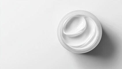 Creamy, white face moisturizer in a clear jar