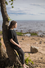 Woman Leaning on a Tree, Gazing at the Sea