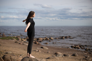 Young Woman Walking on Rocks at the Beach