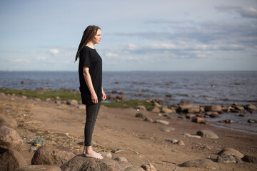 Young Woman Walking on Rocks at the Beach