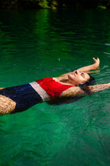 Young Woman Swimming in a Crystal-Clear Alpine Lake