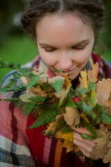 Woman with Dreadlocks Holding Autumn Leaves