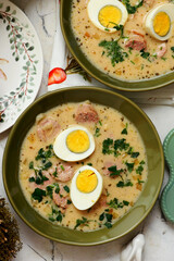 Traditional Polish Easter soup with horseradish, smoked meats and egg..top veiw