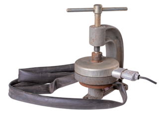 Vulcanization of the bicycle inner tube with a press. Repair of a pierced inner tube. Isolated background.