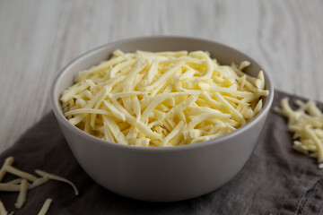Shredded Mozzarella Cheese in a Bowl, side view.