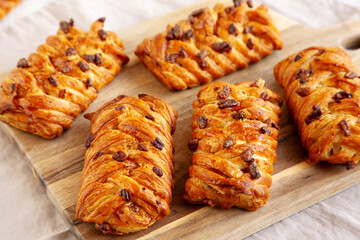 Homemade Maple Pecan Danish Pastry on a wooden board, side view.