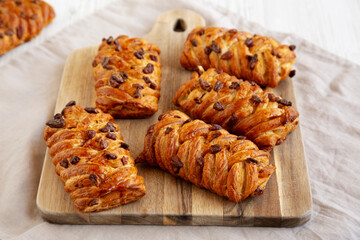 Homemade Maple Pecan Danish Pastry on a wooden board, side view.