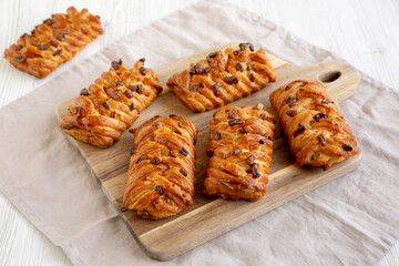 Homemade Maple Pecan Danish Pastry on a wooden board, side view.