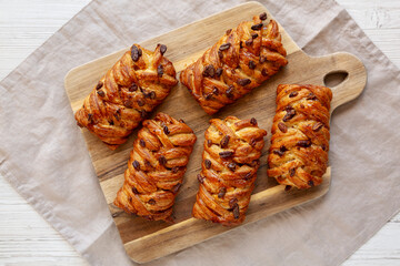 Homemade Maple Pecan Danish Pastry on a wooden board, top view. Flat lay, overhead, from above.