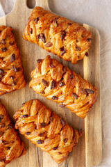 Homemade Maple Pecan Danish Pastry on a wooden board, top view. Flat lay, overhead, from above.
