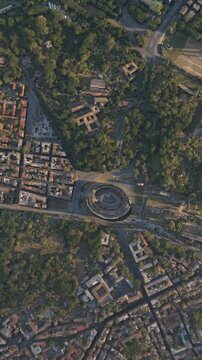 Aerial top view at sunset of the Colosseum in the city of Rome. Italy