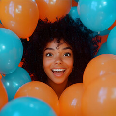 A crazy joyful and excited young black woman with curly hair her face emerging from a sea of vibrant Orange balloons She has an ecstatic and excited expression