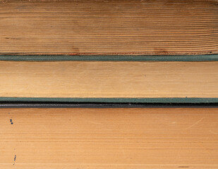 Old book stack pages texture. Vintage books background, antique library collection closeup