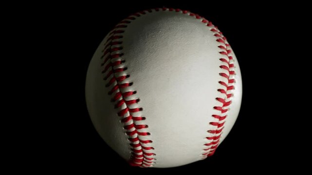 Rotating White Baseball Ball on Black Background . Filmed on High Speed Cinematic Camera at 1000 fps